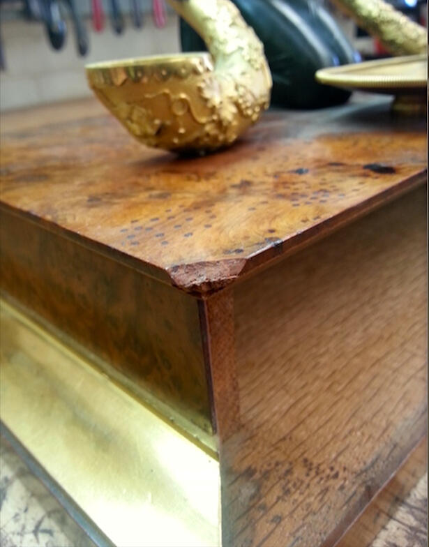 Damaged corner of a Regency yew wood and ormolu inkstand