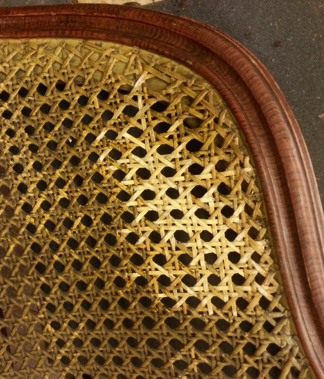Repair to the original cane work on a period settee