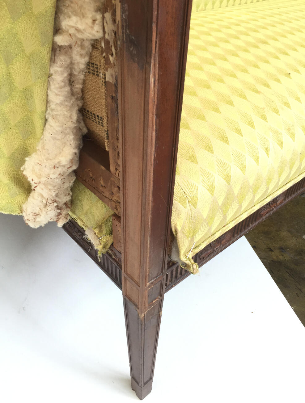 Structural repair to the leg of a period mahogany settee